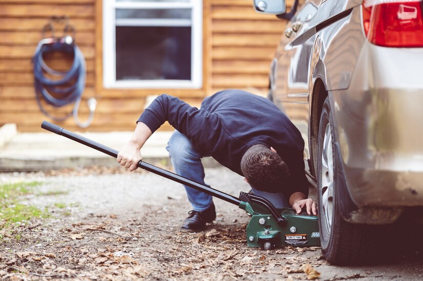 closeup-shot-man-repairing-car-with-tool_181624-45035