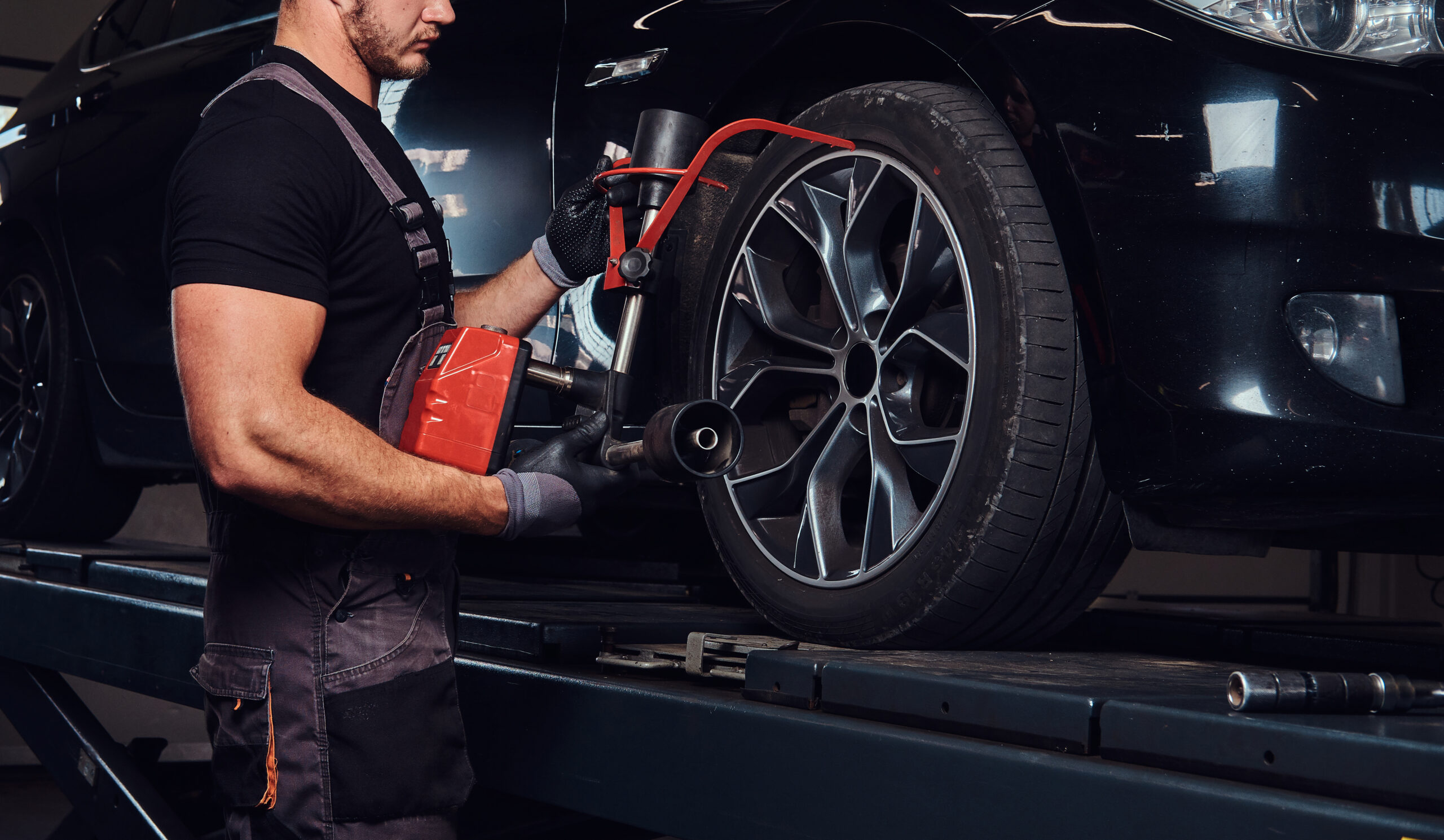 Man is doing balancing for tyres